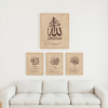 Set of 4 Names of Allah Wall Art displayed above a white sofa, featuring a large Allah print with three smaller complementary names underneath.