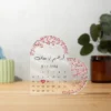 Personalized Arabic Wedding Gift for Couples, Heart-shaped Arabic acrylic plaque features personalized couple names in Arabic Calligraphy, wedding date, and floral decorations along the edges.