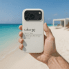 Male hand holding Personalized Arabic Name Phone Case in a beach